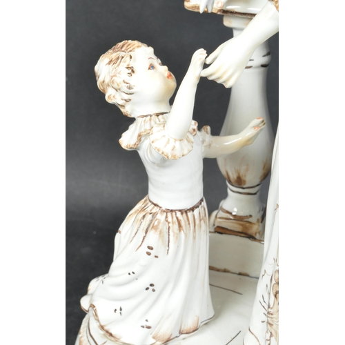 1666 - A vintage 20th century porcelain figural table lamp. The lamp base being modelled as a lady in hat a... 