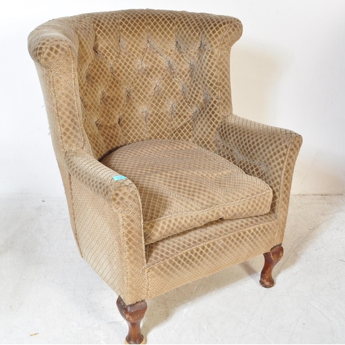 1675 - A 1930s Queen Anne revival wing back arm chair. The chair having a rounded upright backrest with but... 