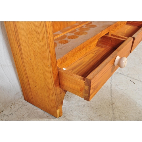 1677 - A 20th Century pine shelving unit / bookcase. The unit having a flared top with three shelves and th... 