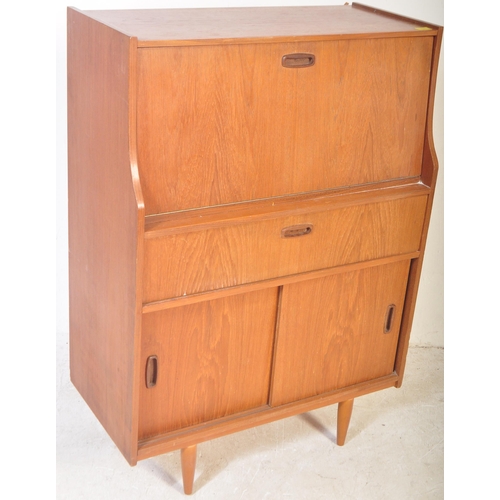 1241 - Mid century teak wood upright Danish influence bureau desk. The  upright body with fall front bureau... 