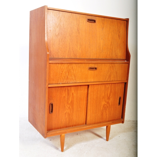 1241 - Mid century teak wood upright Danish influence bureau desk. The  upright body with fall front bureau... 