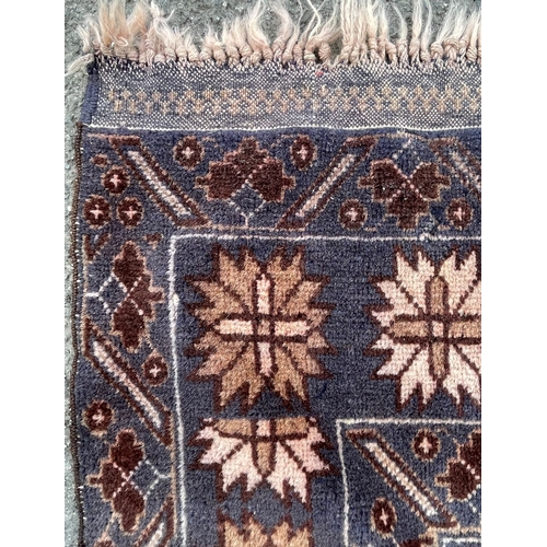 1466 - A vintage mid 20th Century Caucasic Kazak floor carpet rug. Having central panel with stylized flora... 