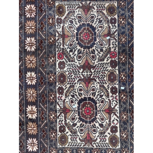 1466 - A vintage mid 20th Century Caucasic Kazak floor carpet rug. Having central panel with stylized flora... 