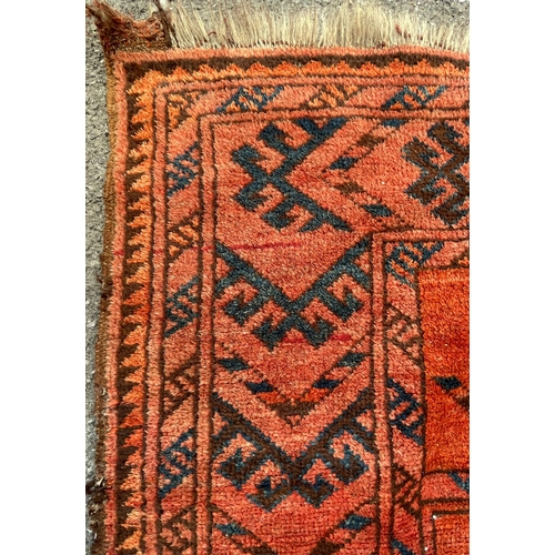 1467 - A vintage 20th Century Turkmenistan Bukhara floor carpet rug. Having two central geometrical strips ... 