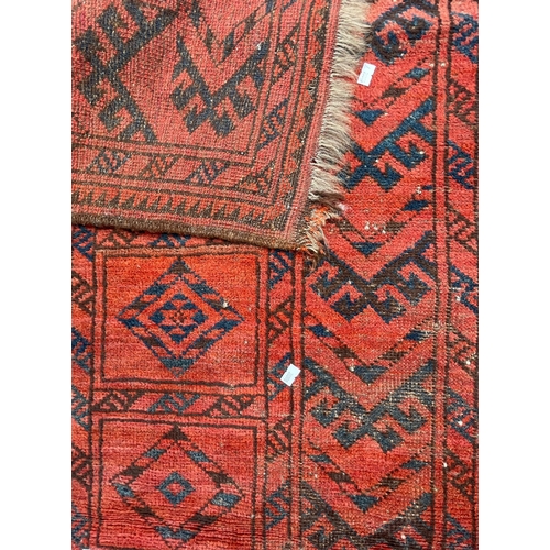 1467 - A vintage 20th Century Turkmenistan Bukhara floor carpet rug. Having two central geometrical strips ... 