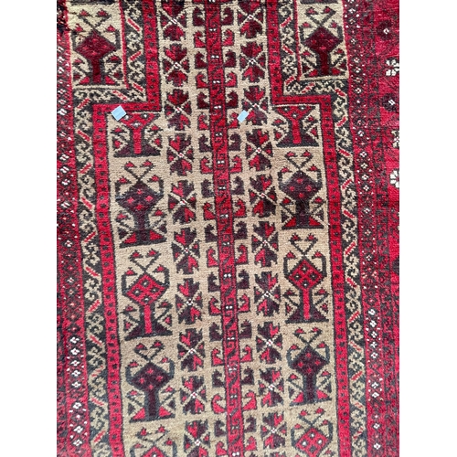 1469 - A vintage 20th Century Persian Islamic Baluch prayer floor carpet rug. Having central geometric pane... 