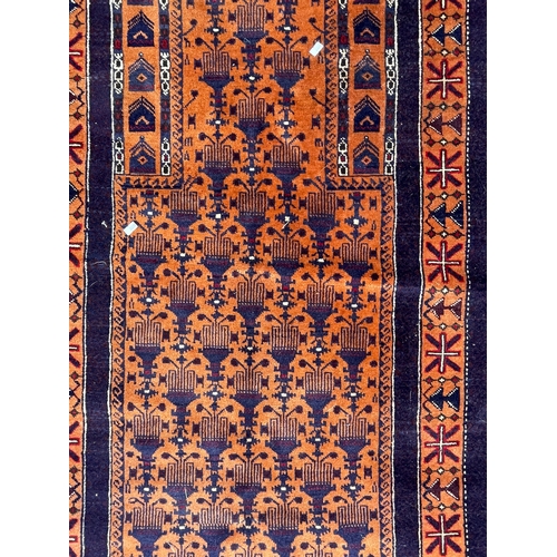 1471 - A vintage 20th Century Persian Islamic Baluch prayer floor carpet rug. Having central panel with a s... 