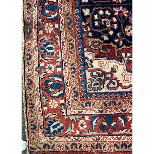 1500 - An early 20th century Persian Islamic North West Sarouk floor carpet rug having a central medallion ... 