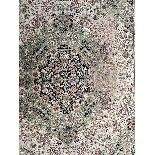 1503 - A mid 20th century Persian Islamic Shiraz floor carpet rug on green tones ground with central floral... 