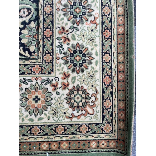 1503 - A mid 20th century Persian Islamic Shiraz floor carpet rug on green tones ground with central floral... 