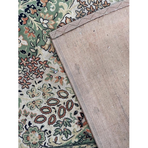 1503 - A mid 20th century Persian Islamic Shiraz floor carpet rug on green tones ground with central floral... 