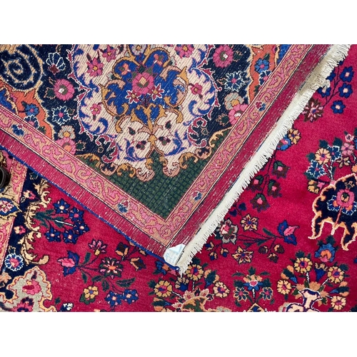 1519 - A mid 20th century Meshed Persian Islamic floor carpet rug having central floral medallion on a mage... 