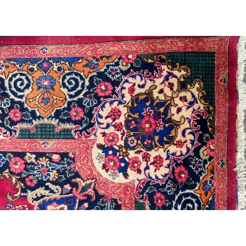 1519 - A mid 20th century Meshed Persian Islamic floor carpet rug having central floral medallion on a mage... 