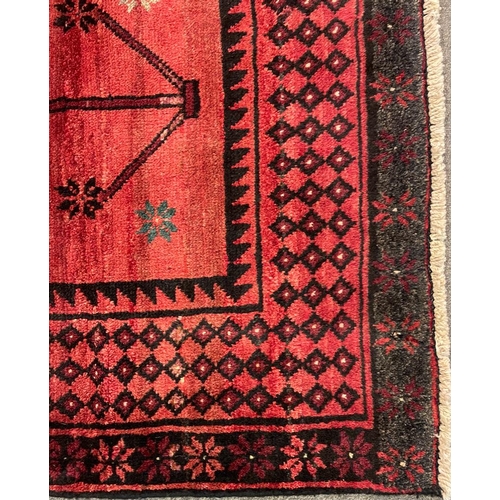 1534 - An early 20th century Persian Islamic North West Kurdish floor carpet rug having red ground with a c... 