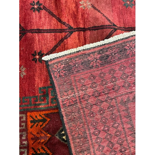 1534 - An early 20th century Persian Islamic North West Kurdish floor carpet rug having red ground with a c... 