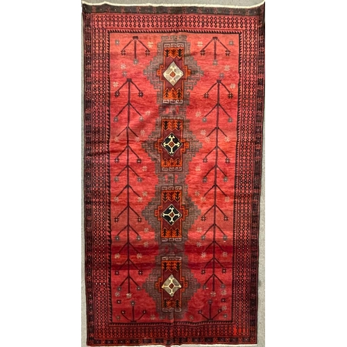 1534 - An early 20th century Persian Islamic North West Kurdish floor carpet rug having red ground with a c... 