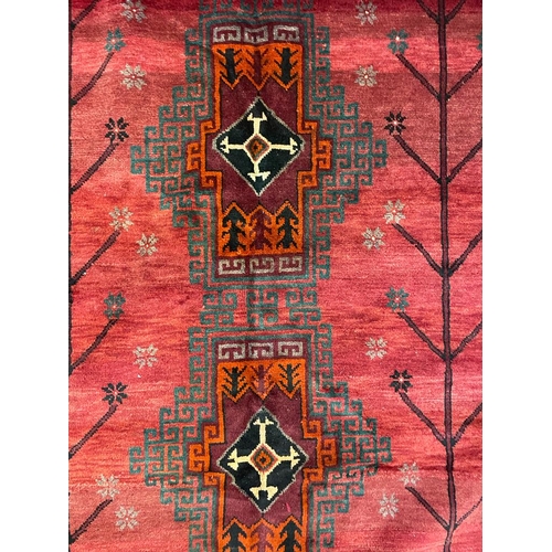 1534 - An early 20th century Persian Islamic North West Kurdish floor carpet rug having red ground with a c... 