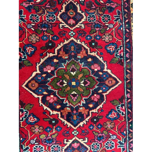 1536 - An early 20th century Persian Islamic Northwest Sarouk runner floor carpet rug having a floral centr... 