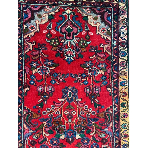 1536 - An early 20th century Persian Islamic Northwest Sarouk runner floor carpet rug having a floral centr... 