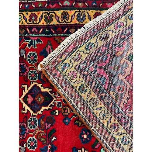 1536 - An early 20th century Persian Islamic Northwest Sarouk runner floor carpet rug having a floral centr... 