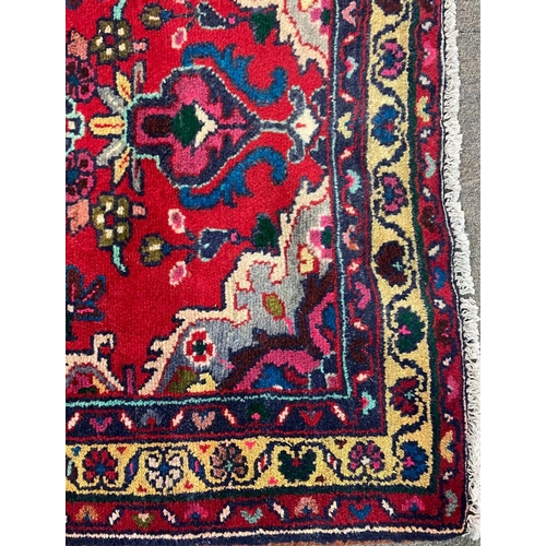 1536 - An early 20th century Persian Islamic Northwest Sarouk runner floor carpet rug having a floral centr... 