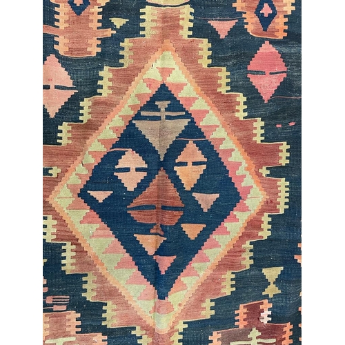 1548 - An early 20th century Persian Islamic Kurdie Kilim floor carpet rug having a series of three central... 