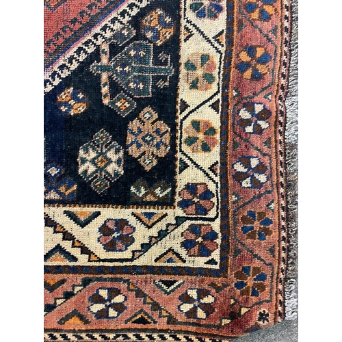 1550 - An early 20th century Central Persian Islamic Lori floor carpet rug having central red medallion wit... 