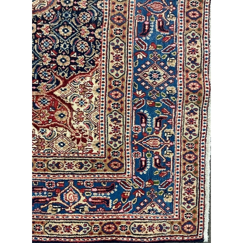 1552 - An early 20th century Persian Islamic North East Moud floor carpet rug having a central medallion on... 