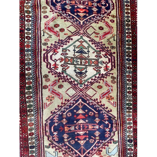 1563 - An vintage mid 20th century Persian Islamic Malayer runner floor carpet rug having a beige backgroun... 