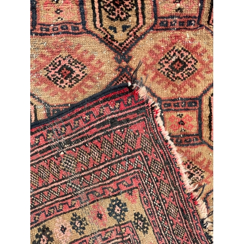 1569 - An vintage mid 20th century Afghan Bukhara floor carpet rug having a series of repeating central med... 