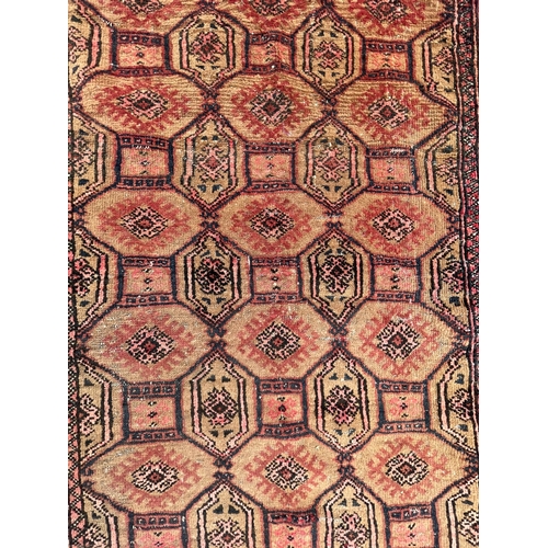 1569 - An vintage mid 20th century Afghan Bukhara floor carpet rug having a series of repeating central med... 