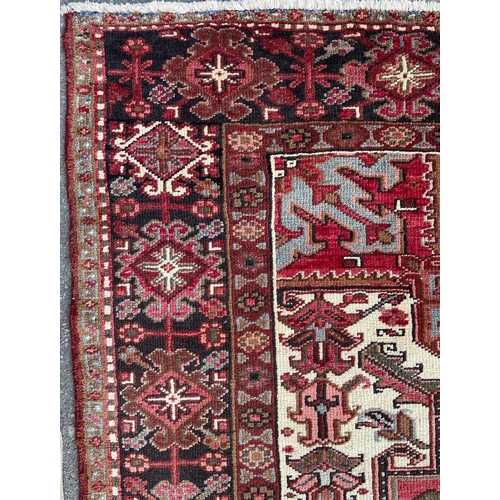 1638 - An early 20th century Northwest Persian Islamic Heriz floor carpet rug having n intricate central me... 