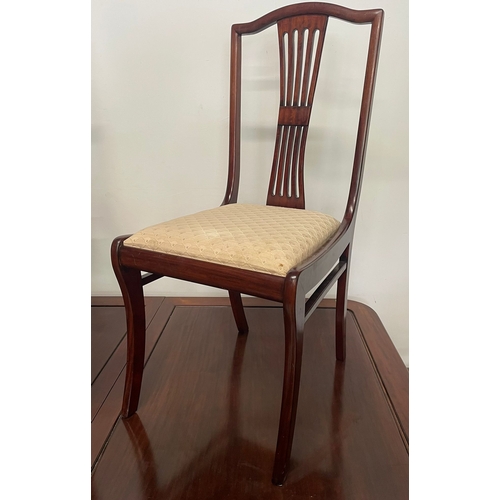 1665 - A vintage 20th century Regency revival mahogany dining table and chairs. The table having a reeded b... 