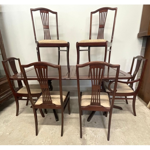 1665 - A vintage 20th century Regency revival mahogany dining table and chairs. The table having a reeded b... 