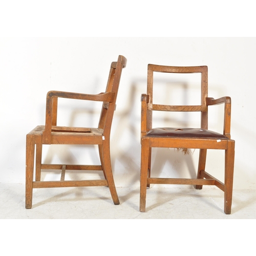 1688 - A pair of 1930s oak framed carver chairs. The chairs having rounded back rests with shaped arms rest... 