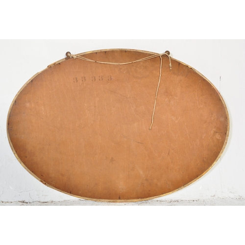 1694 - A vintage retro 20th century oval wall hanging mirror having gilt frame with decorative moulding to ... 