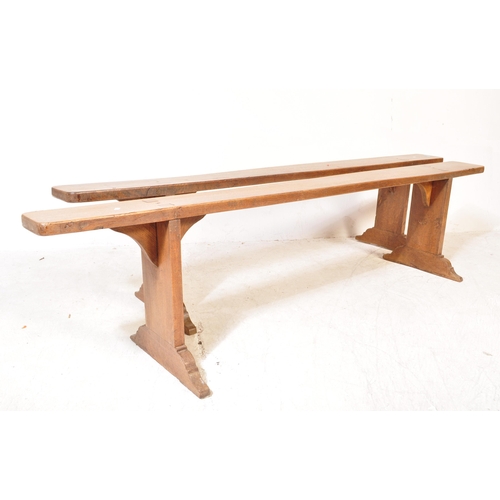 1695 - A pair of 19th century French refectory pig benches. Each with shaped single plant tops of fruitwood... 