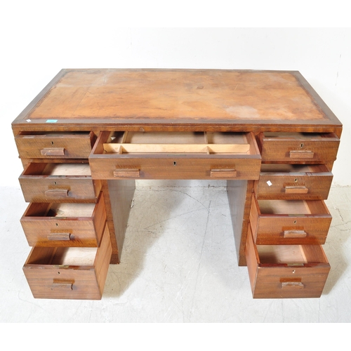 1704 - A 1930's Art Deco mahogany twin pedestal office desk. Each pedestal raised on a plinth base with pul... 