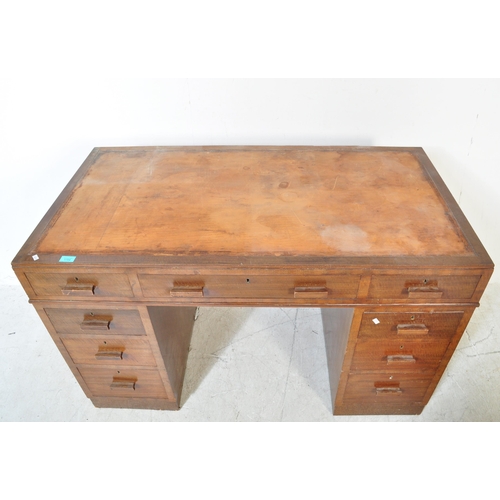 1704 - A 1930's Art Deco mahogany twin pedestal office desk. Each pedestal raised on a plinth base with pul... 