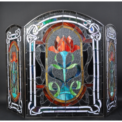 1721 - An early 20th century stained leaded glass triptych fire screen having variety of colour glass and l... 