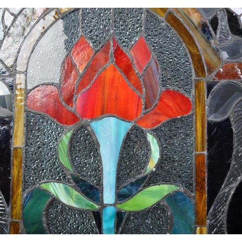 1721 - An early 20th century stained leaded glass triptych fire screen having variety of colour glass and l... 