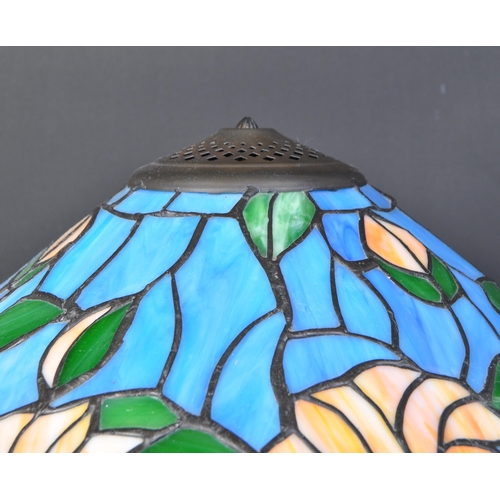 1723 - Two vintage 20th century Tiffany manner stained and leaded glass matching ceiling light and table la... 