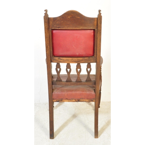 1734 - A late 19th Century Arts & Crafts oak carved hall chair. Having an arched carved top flanked by fini... 