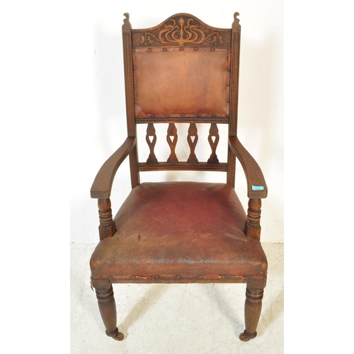 1734 - A late 19th Century Arts & Crafts oak carved hall chair. Having an arched carved top flanked by fini... 