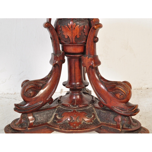 1735 - A Victorian 19th century carved mahogany & upholstered revolving piano stool having an intricate car... 