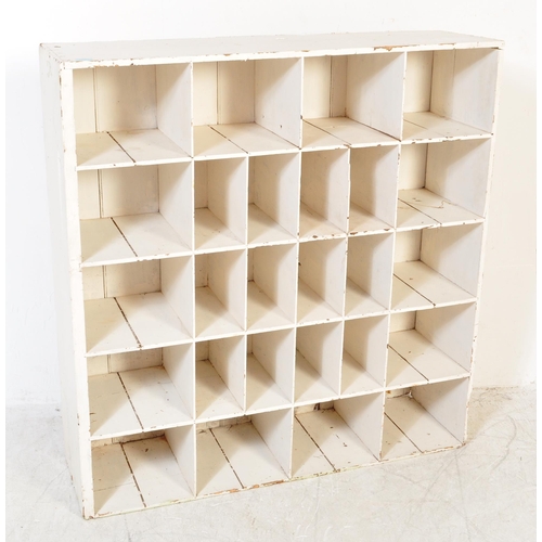 1737 - A vintage 20th Century painted pine wood pigeon hole shelving wall unit. Of rectangular form with fi... 