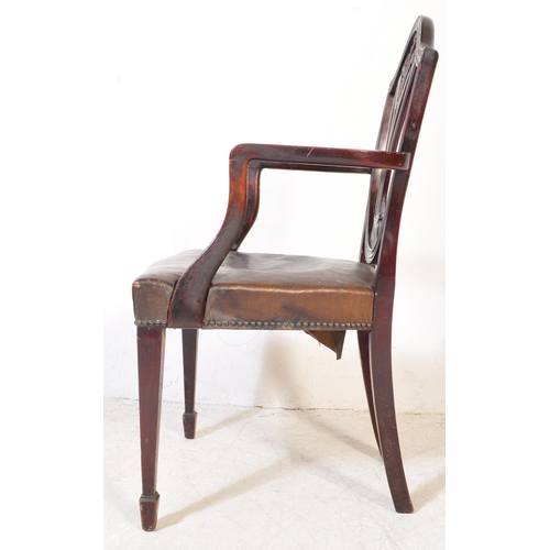 1745 - A 19th Century Arts & Craft dark mahogany dining / hall chair. With an arched top with shield back r... 