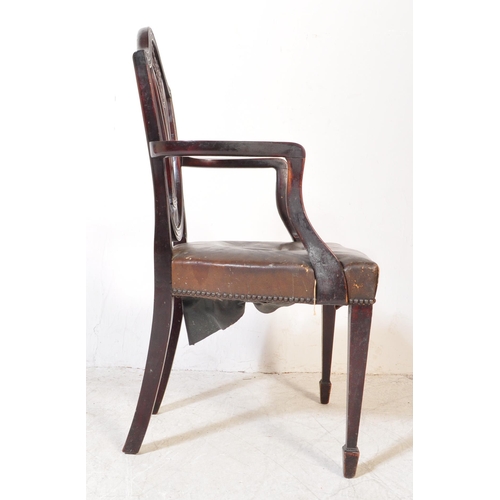 1745 - A 19th Century Arts & Craft dark mahogany dining / hall chair. With an arched top with shield back r... 