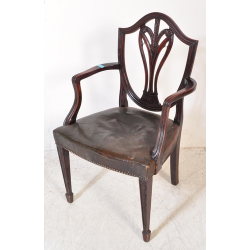 1745 - A 19th Century Arts & Craft dark mahogany dining / hall chair. With an arched top with shield back r... 