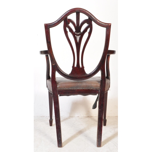 1745 - A 19th Century Arts & Craft dark mahogany dining / hall chair. With an arched top with shield back r... 